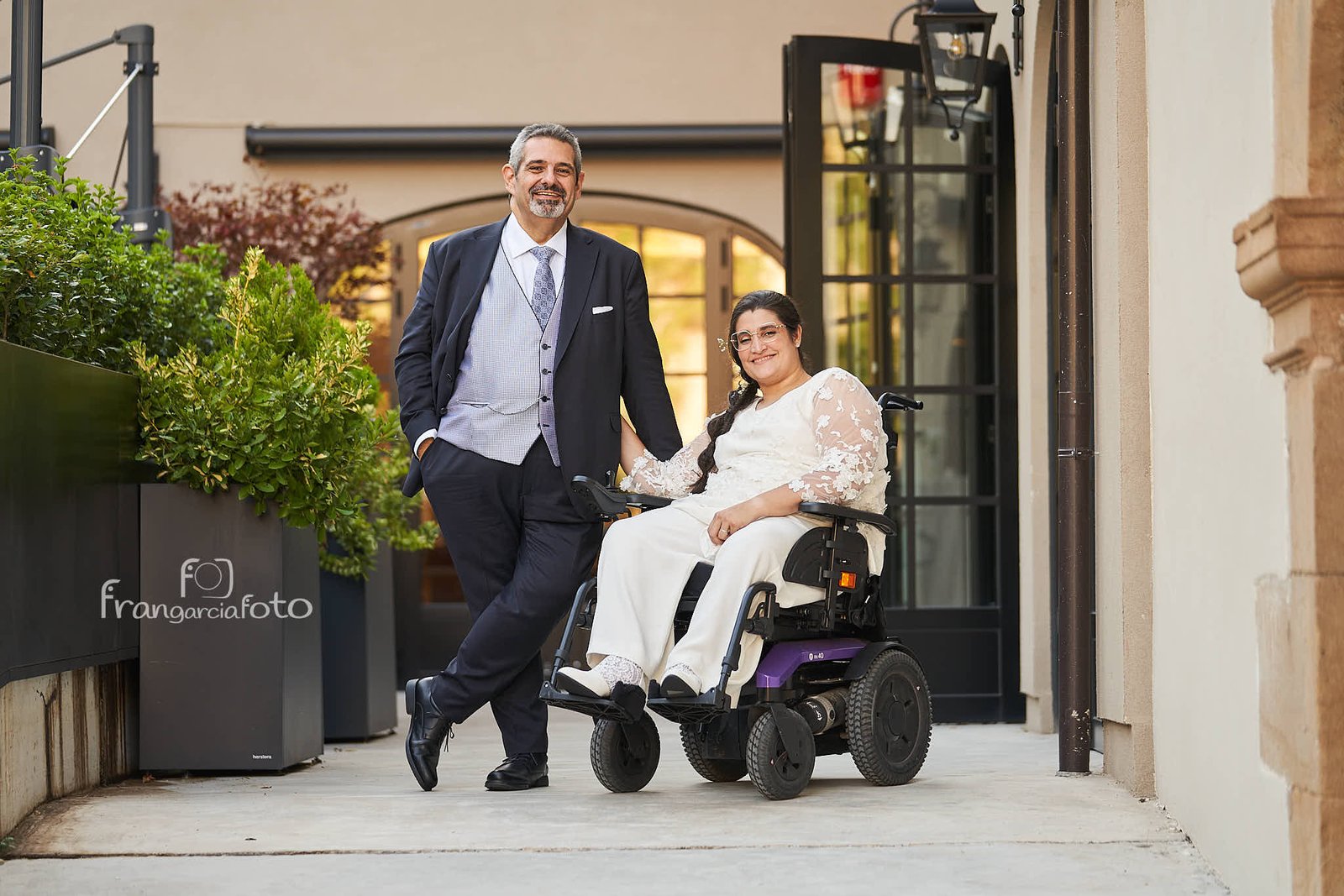 Pareja de novios posando en un jardín interior de un Hotel